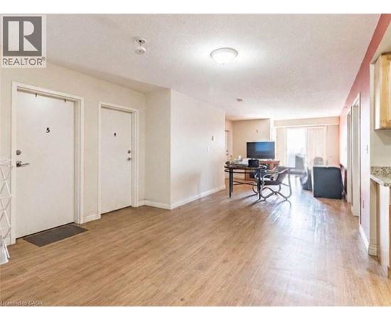 A living room with a television and a dining table.
