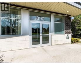 The image shows the front of a building with the number 392 on it.
