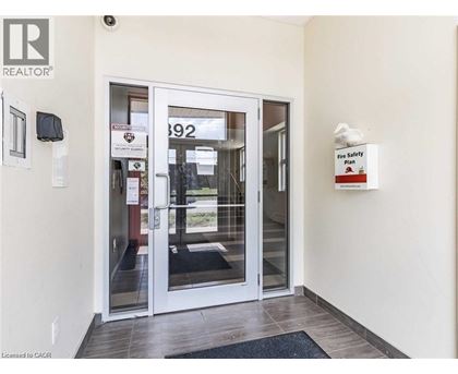 A white door with a glass window and a sign that says "Fire Safety Plan".