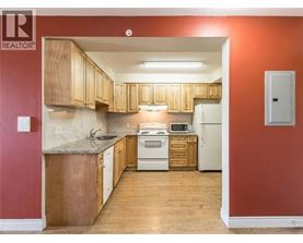 A kitchen with wooden cabinets and a white refrigerator.