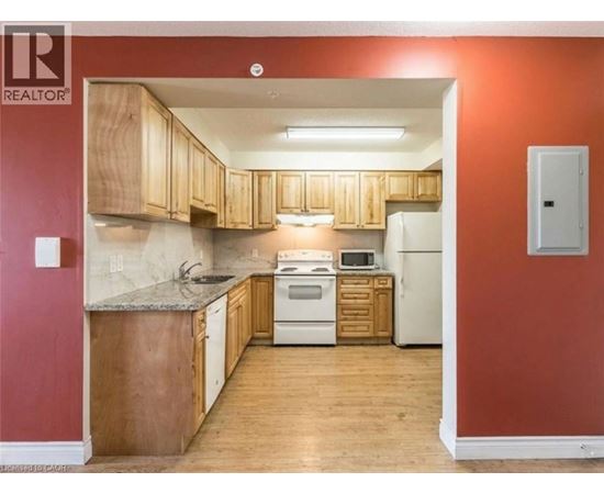 A kitchen with wooden cabinets and a white refrigerator.
