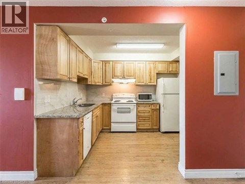 A kitchen with wooden cabinets and a white refrigerator.