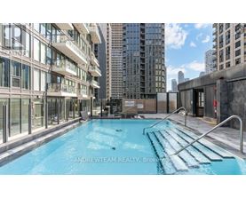 A pool in a city setting with buildings in the background.