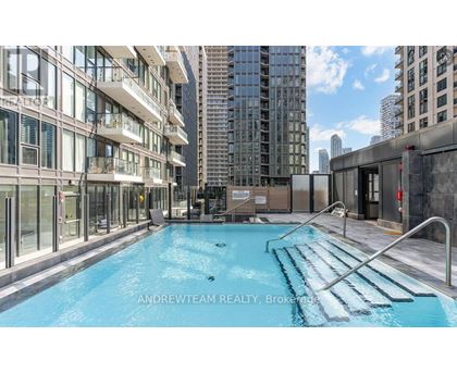 A pool in a city setting with buildings in the background.