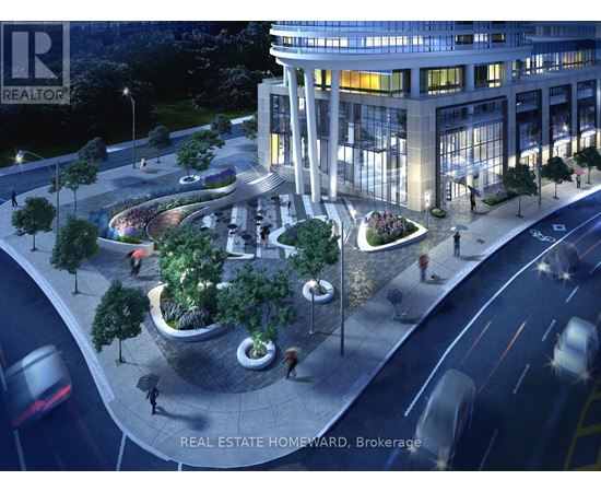 A nighttime view of a city street with a large building and a roundabout with trees.