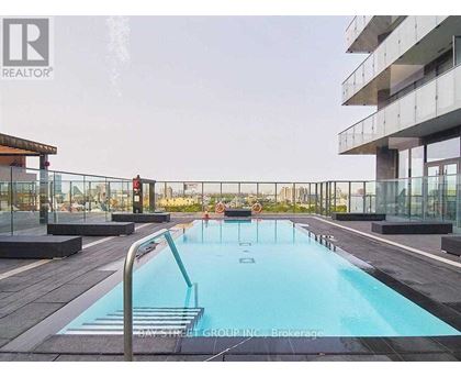 A pool on a balcony with people in it.
