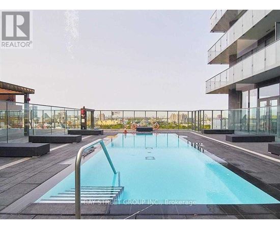 A pool on a balcony with people in it.