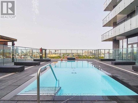 A pool on a balcony with people in it.
