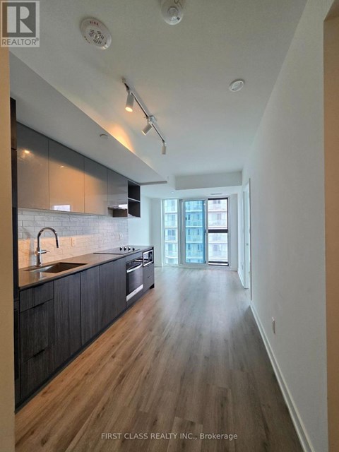 A kitchen with dark wood cabinets and a white counter top.
