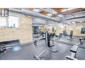 A gym with a variety of equipment including a squat rack, bench, and weights.