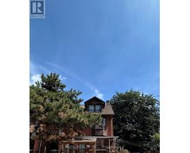 A building with a sign that says "IDI REALTY INC." is in front of some trees.