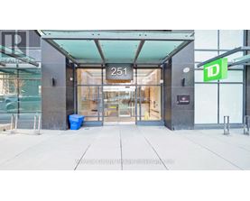The entrance to a building with a glass door and a sign that reads "251".