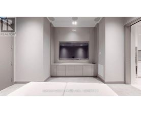 A modern living room with a flat screen TV and a built in cabinet.
