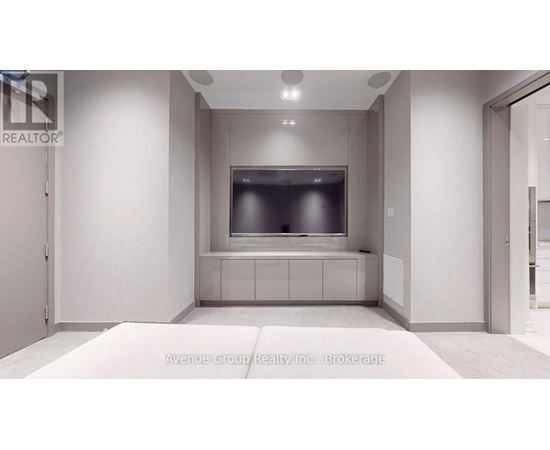 A modern living room with a flat screen TV and a built in cabinet.