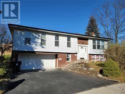 A two-story house with a garage is for sale.