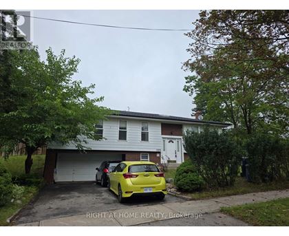 A yellow car is parked in front of a garage.