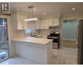 A modern kitchen with a large island and stainless steel appliances.