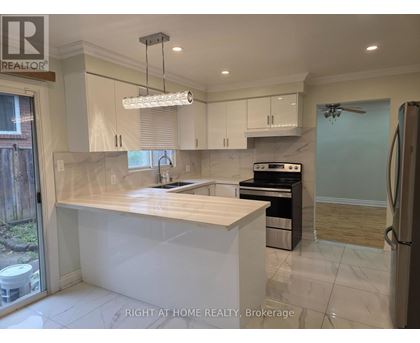 A modern kitchen with a large island and stainless steel appliances.