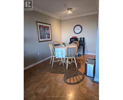 A dining room with a table set for four.