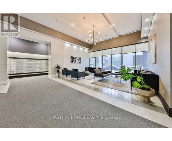 A spacious office lobby with a reception desk and seating area.