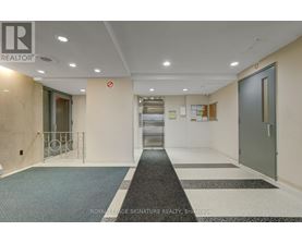 A hallway with a Royal LePage Signature Realty logo on the wall.