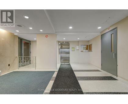 A hallway with a Royal LePage Signature Realty logo on the wall.