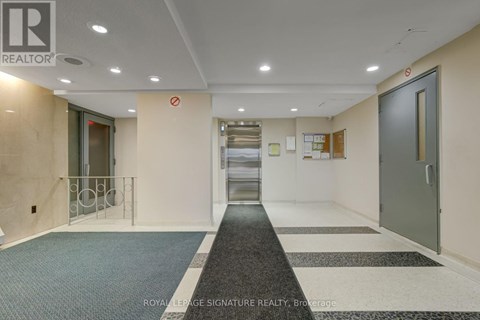 A hallway with a Royal LePage Signature Realty logo on the wall.