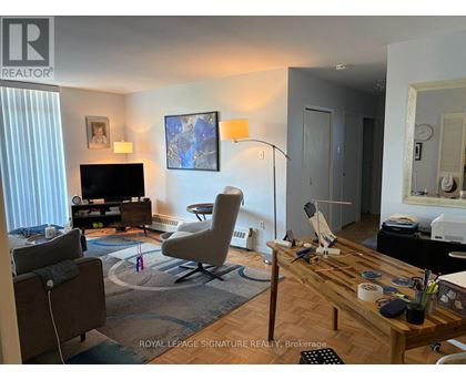 A living room with a television, a chair, and a table.