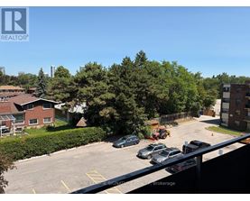 A parking lot with cars and a building in the background.