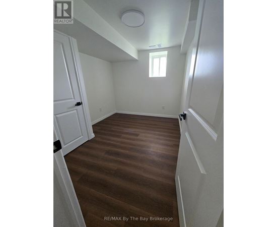 A room with wooden floors and white walls.