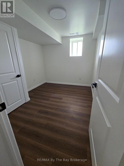 A room with wooden floors and white walls.