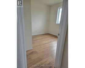 A room with wooden floors and white walls.