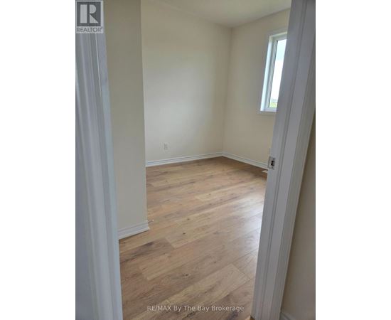 A room with wooden floors and white walls.