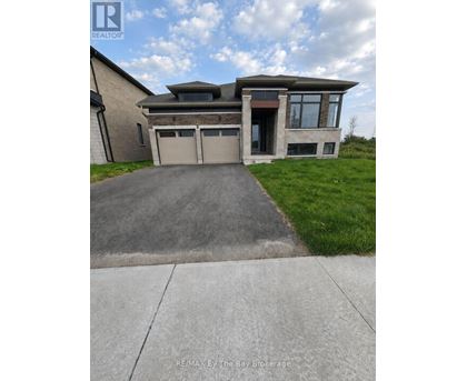 A modern house with a garage is for sale.