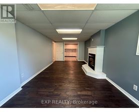 A long hallway with wood floors and white walls.