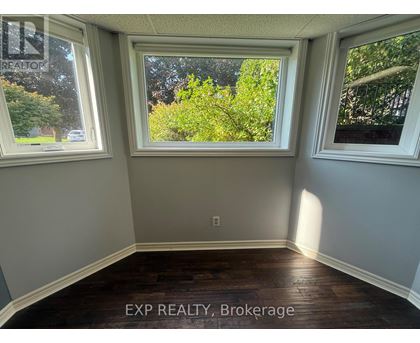 A room with EXP REALTY, Brokerage written on the floor.