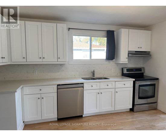 A kitchen with white cabinets and a stainless steel dishwasher.