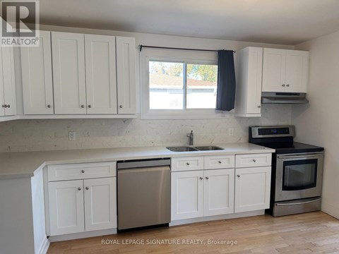 A kitchen with white cabinets and a stainless steel dishwasher.