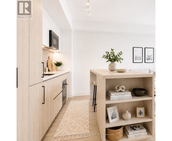 A modern kitchen with a wooden cabinet and a white shelf with various items on it.