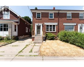 A red brick house with a white door and windows.