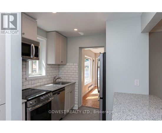 A kitchen with a stove top oven and microwave.