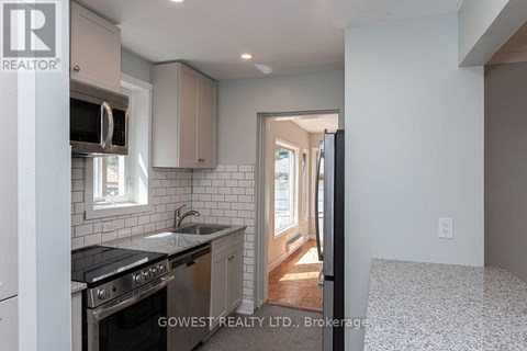 A kitchen with a stove top oven and microwave.