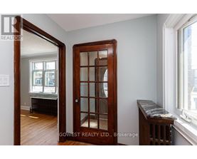 A room with a wooden door and a marble bench.