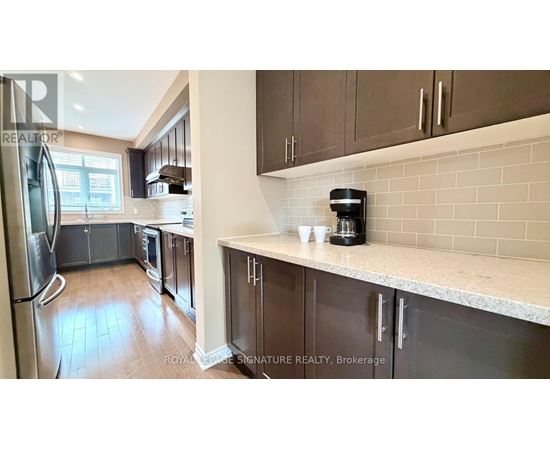 A kitchen with brown cabinets and a white counter.