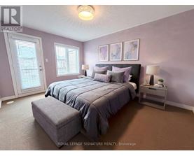 A bedroom with a large bed and a window with blinds.