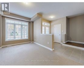 A spacious room with a large window and a door is on the market with Royal LePage Signature Realty in Brokerage.