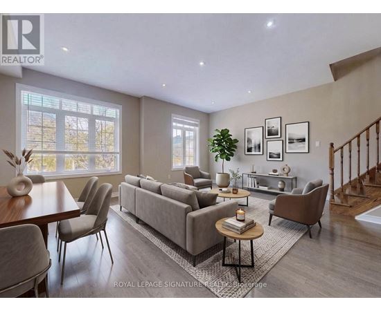 A well-lit living room with a grey sofa and a wooden coffee table.