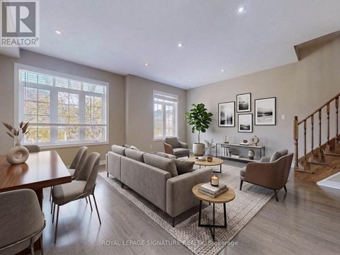 A well-lit living room with a grey sofa and a wooden coffee table.