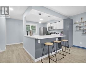 A kitchen with a bar stool and a counter.