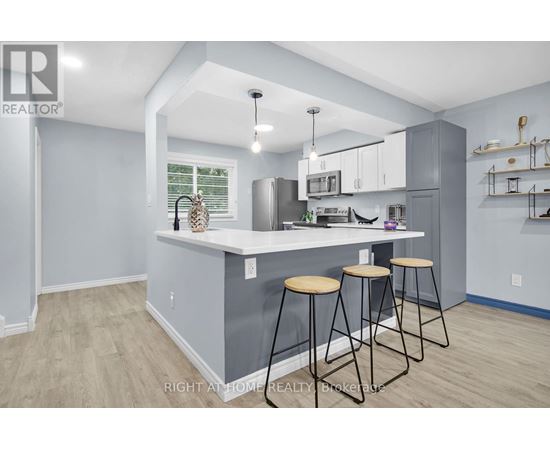 A kitchen with a bar stool and a counter.